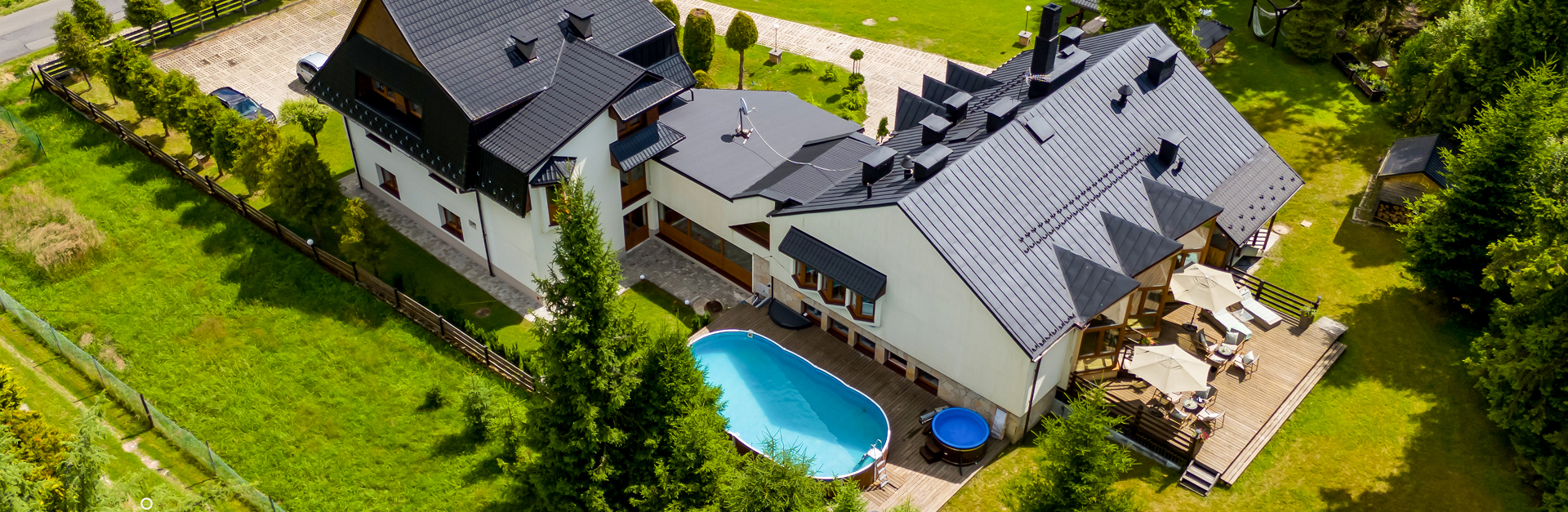 Widok z drona na ośrodek Cisza z tarasem, basenem i balią wśród zieleni